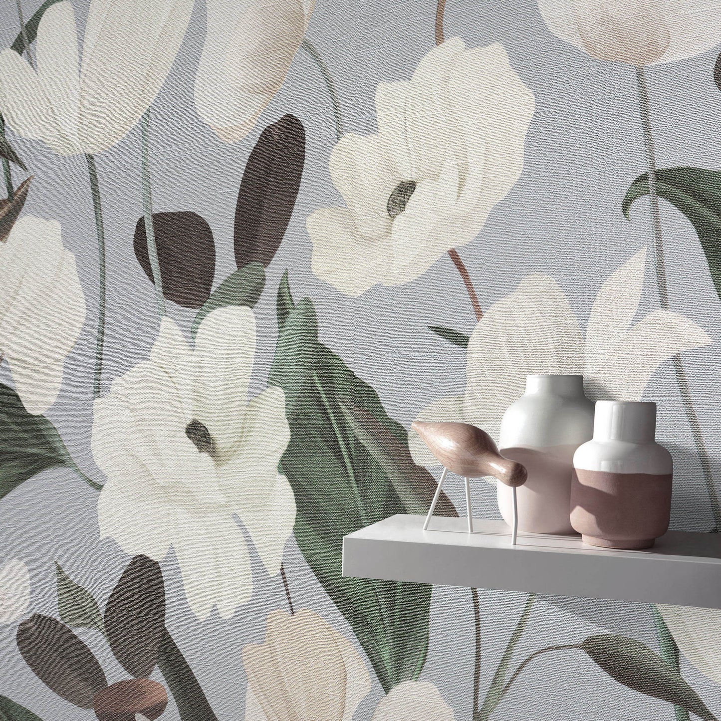 Floral wallpaper with oversized white flowers & green leaves on grey-blue; shelf with pink & white ceramic vases.