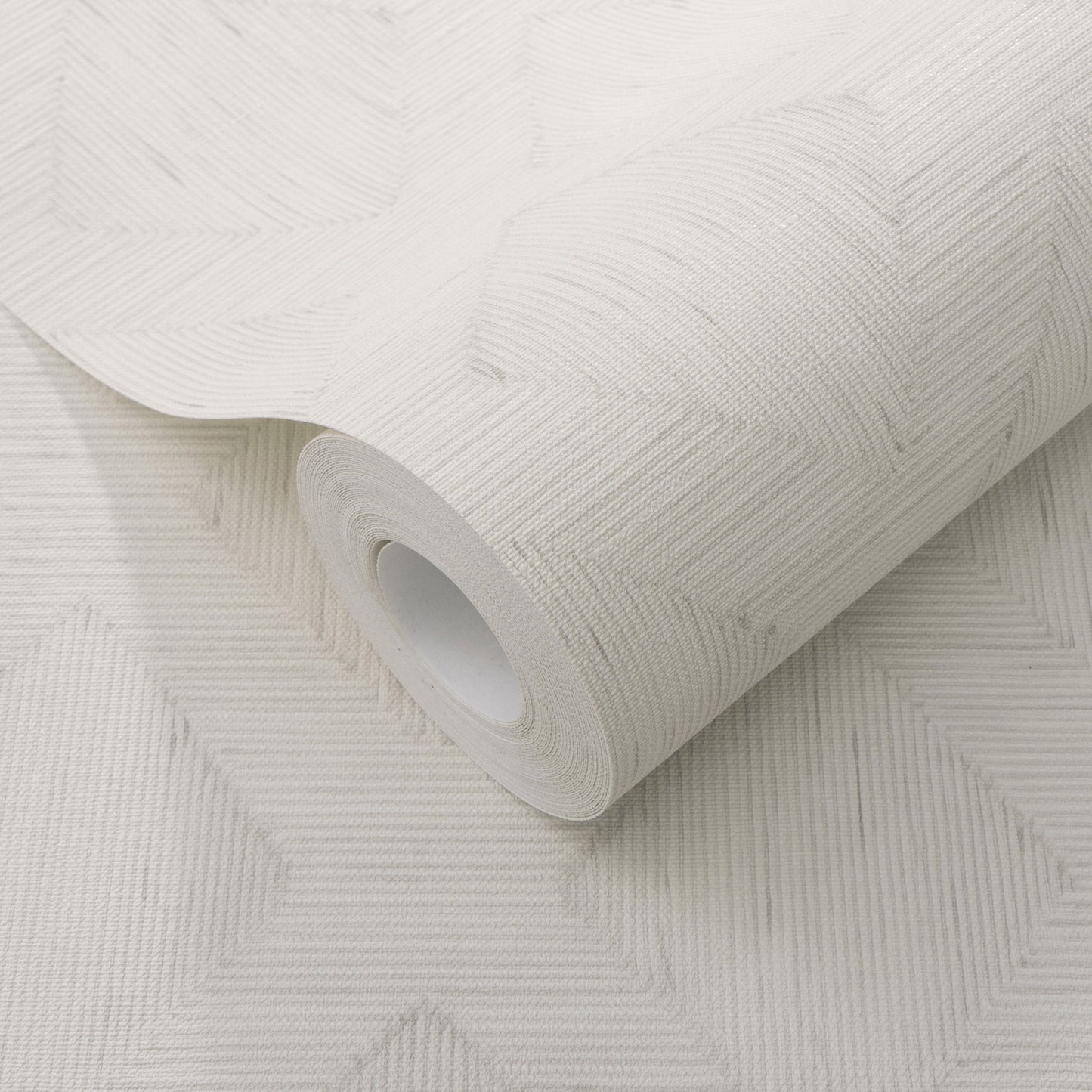 White embossed wallpaper roll with geometric chevron pattern and textured finish.