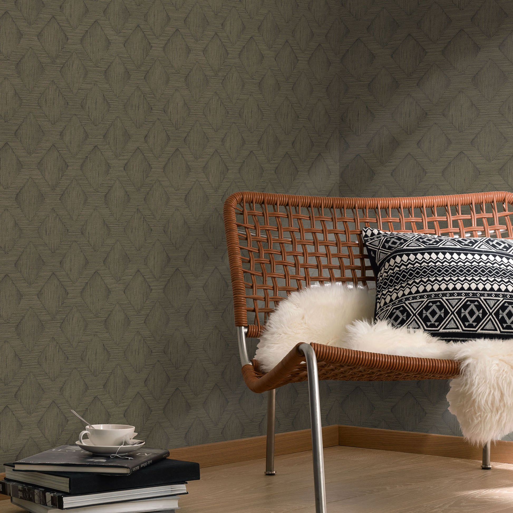 Rattan lounge chair with metal legs, black-white geometric cushion and white faux fur throw; wood floor, grey wallpaper.