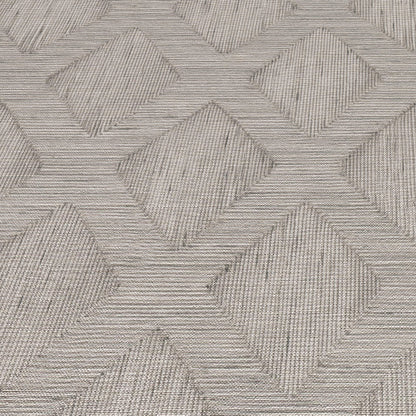 Grey woven rug with an interlocking diamond chevron pattern and subtle textured lines.