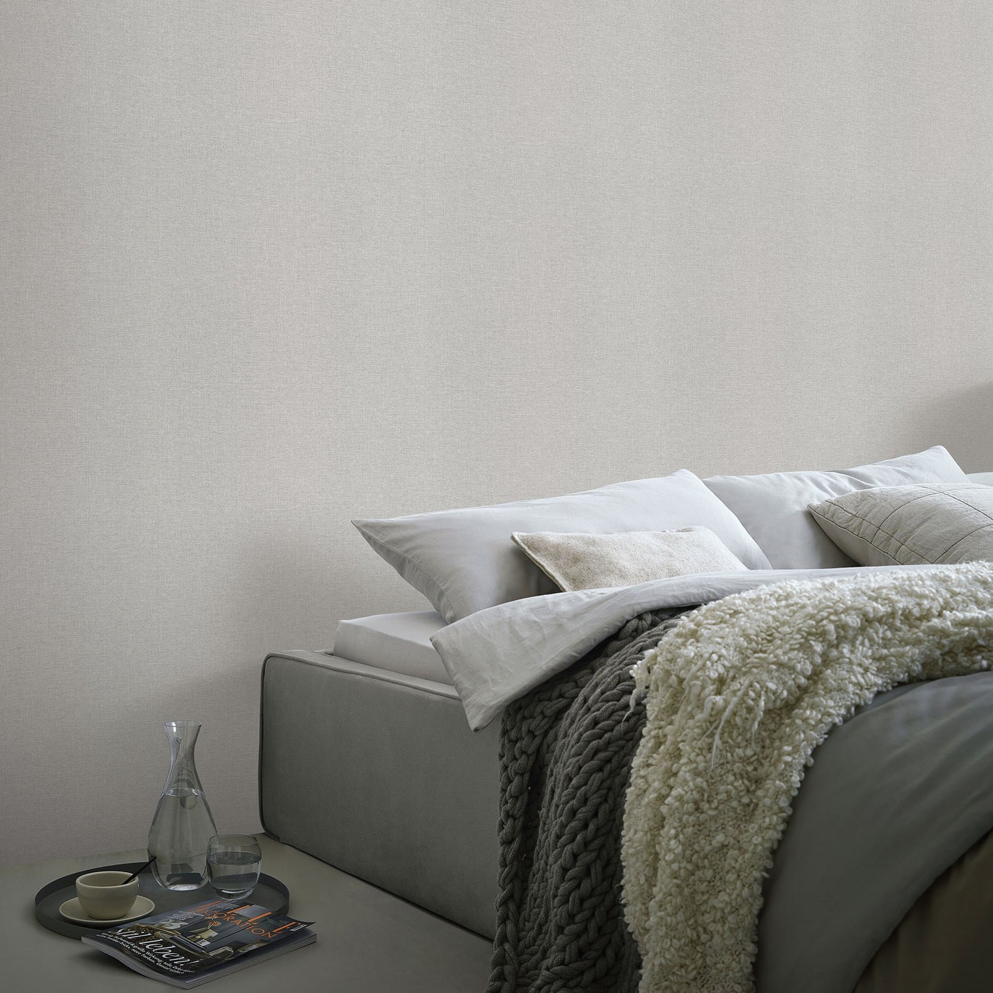 Light gray linen serenity wallpaper with a traditional pattern; subtle, textured wall surface.