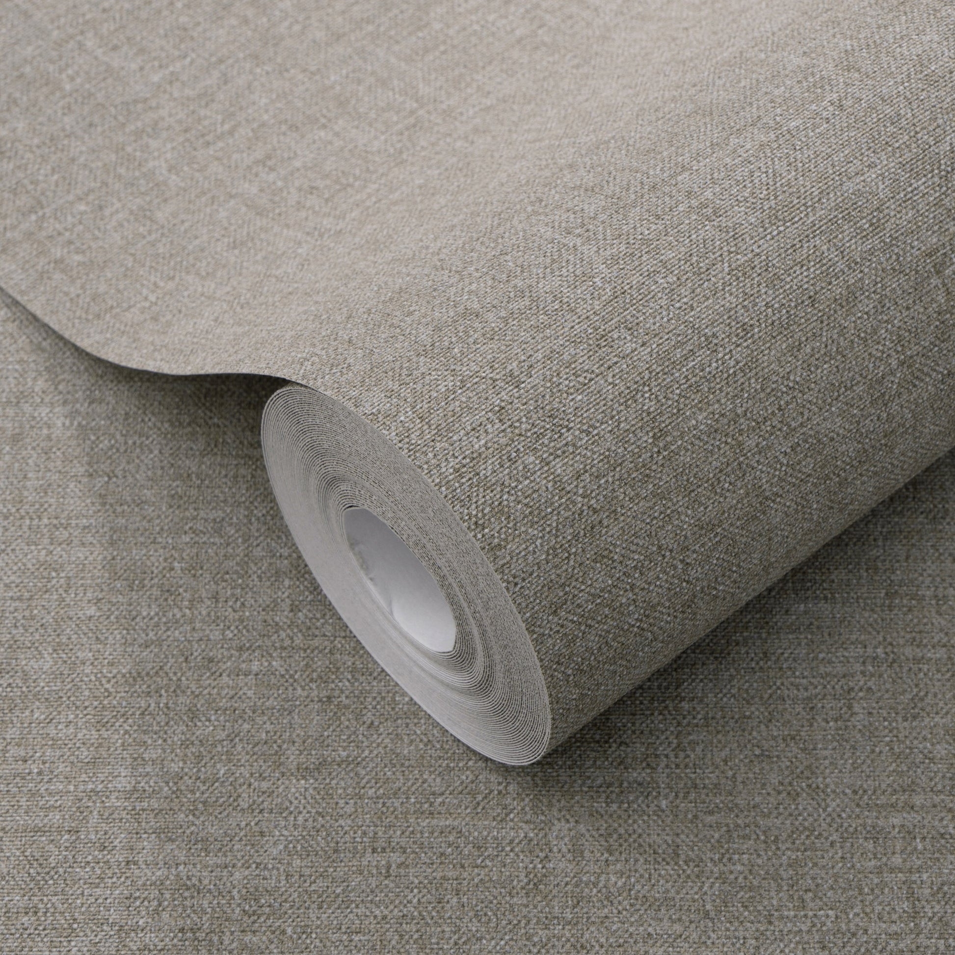 Dark gray linen-textured wallpaper roll with a traditional pattern, partially unrolled.