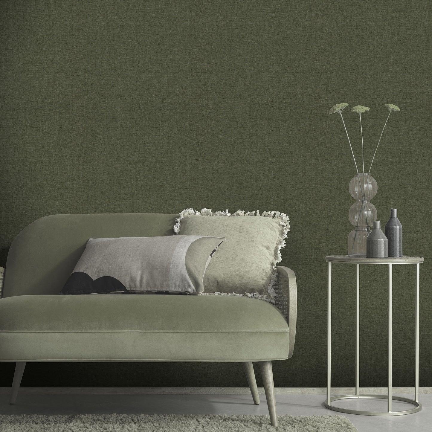 Sage-green wallpaper with a linen texture in a traditional green pattern.