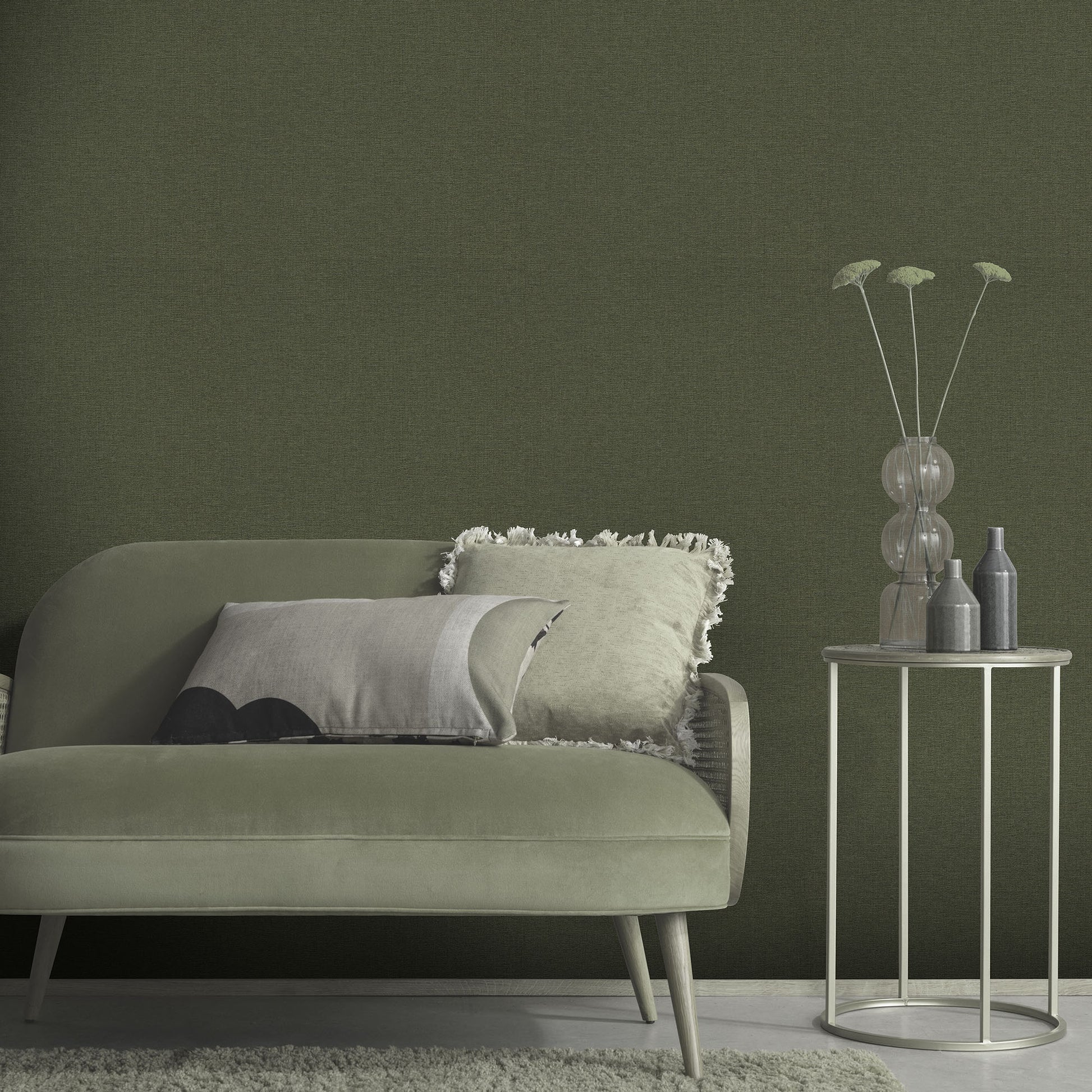 Sage-green wallpaper with a linen texture in a traditional green pattern.