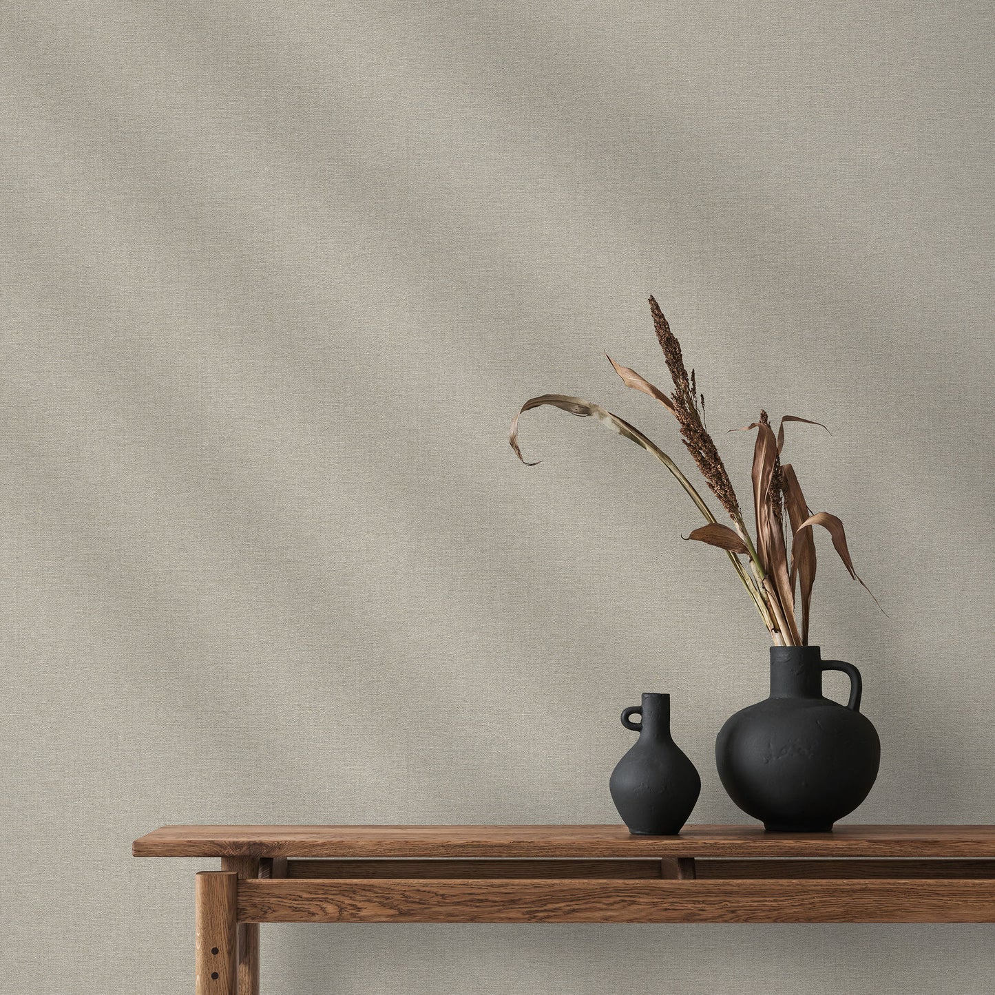 Taupe linen-textured wallpaper with a subtle traditional pattern on the wall.