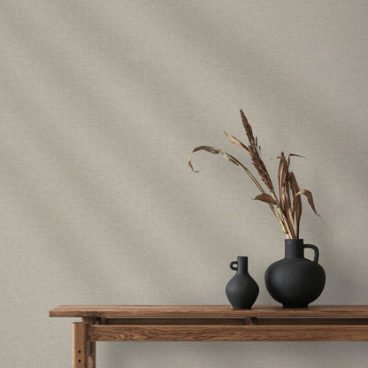 Taupe linen-textured wallpaper with a subtle traditional pattern on the wall.