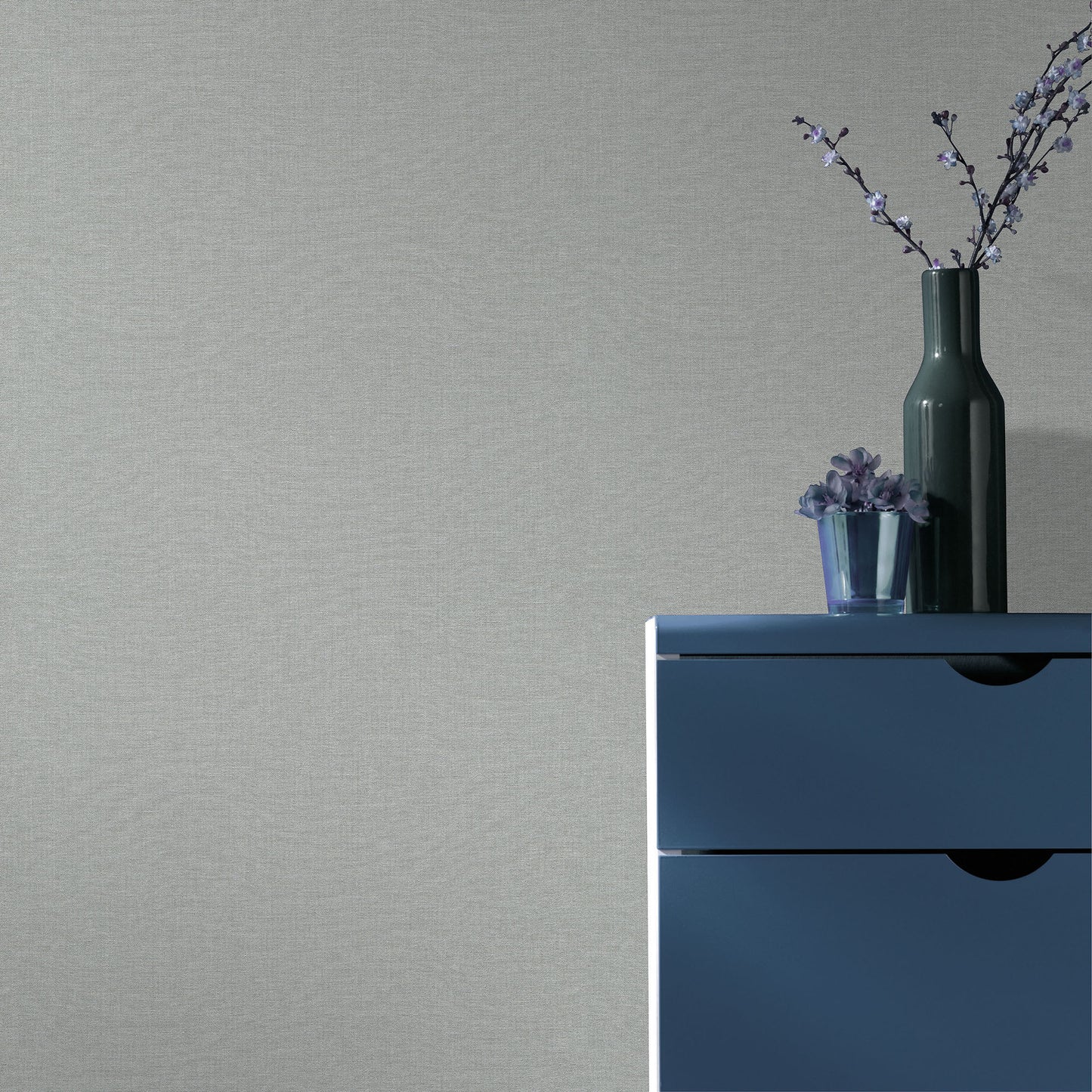 Blue wallpaper with a subtle linen texture and traditional blue pattern on the wall.