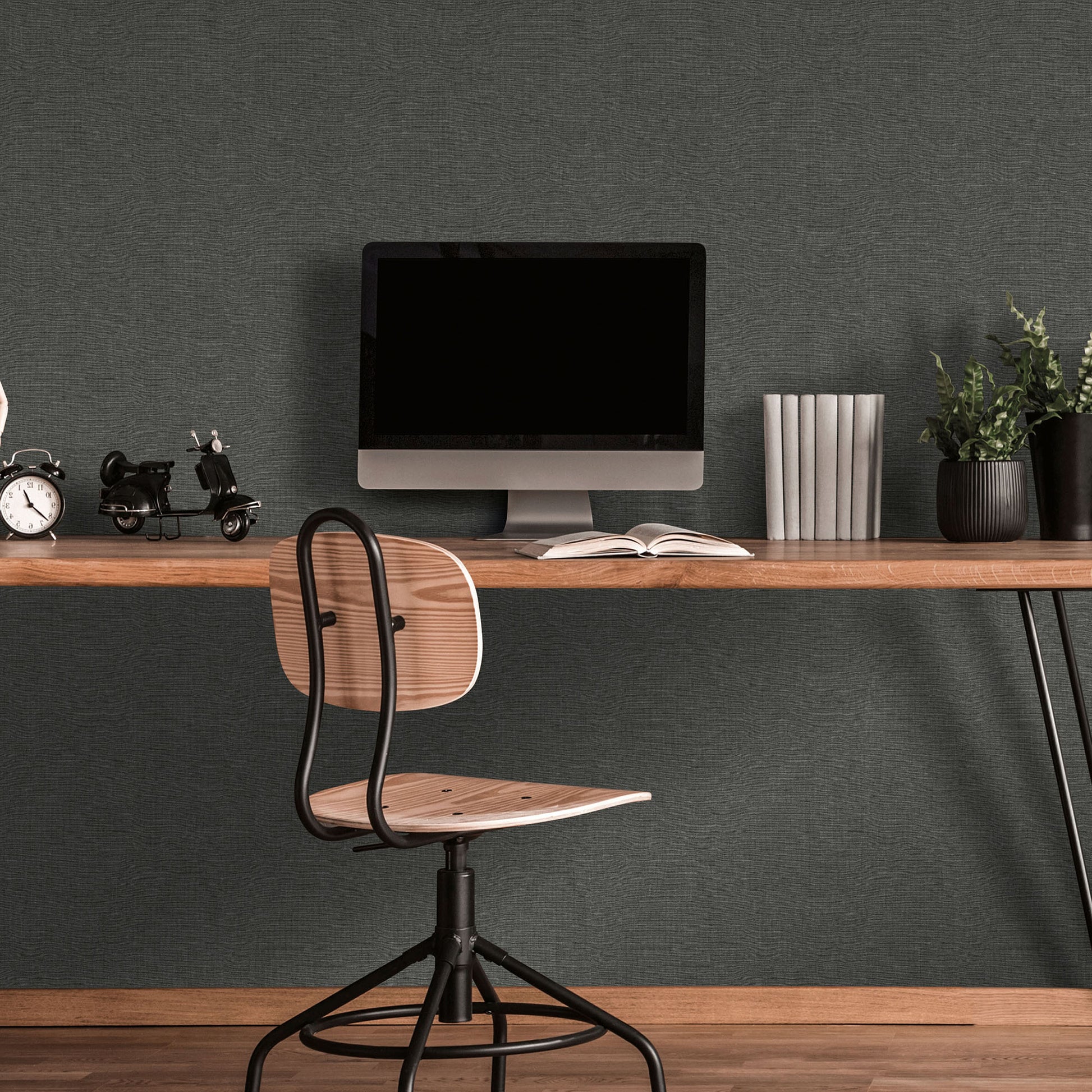 Black wallpaper with a linen-textured pattern on the wall.