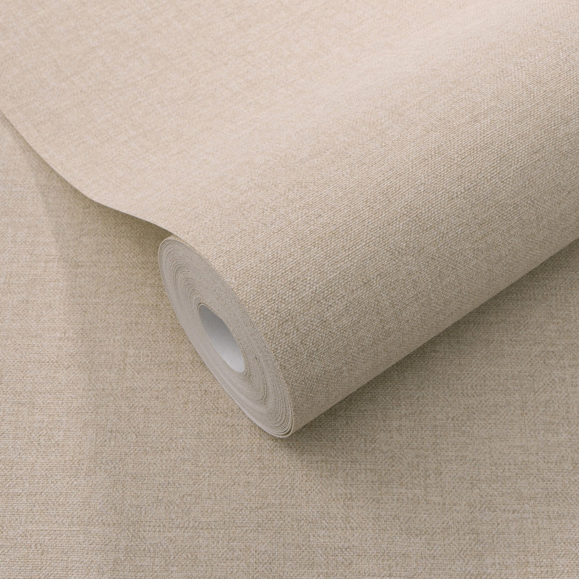 Pink linen-textured wallpaper roll with white core and woven fabric look.