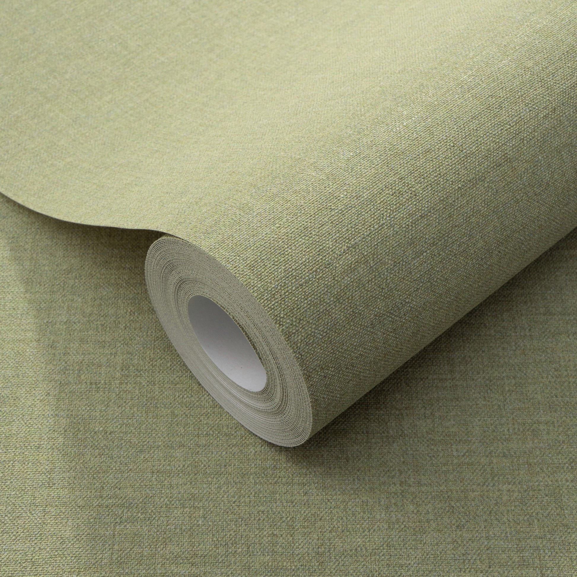 Sage-green textured wallpaper roll with linen-like weave and cardboard core.