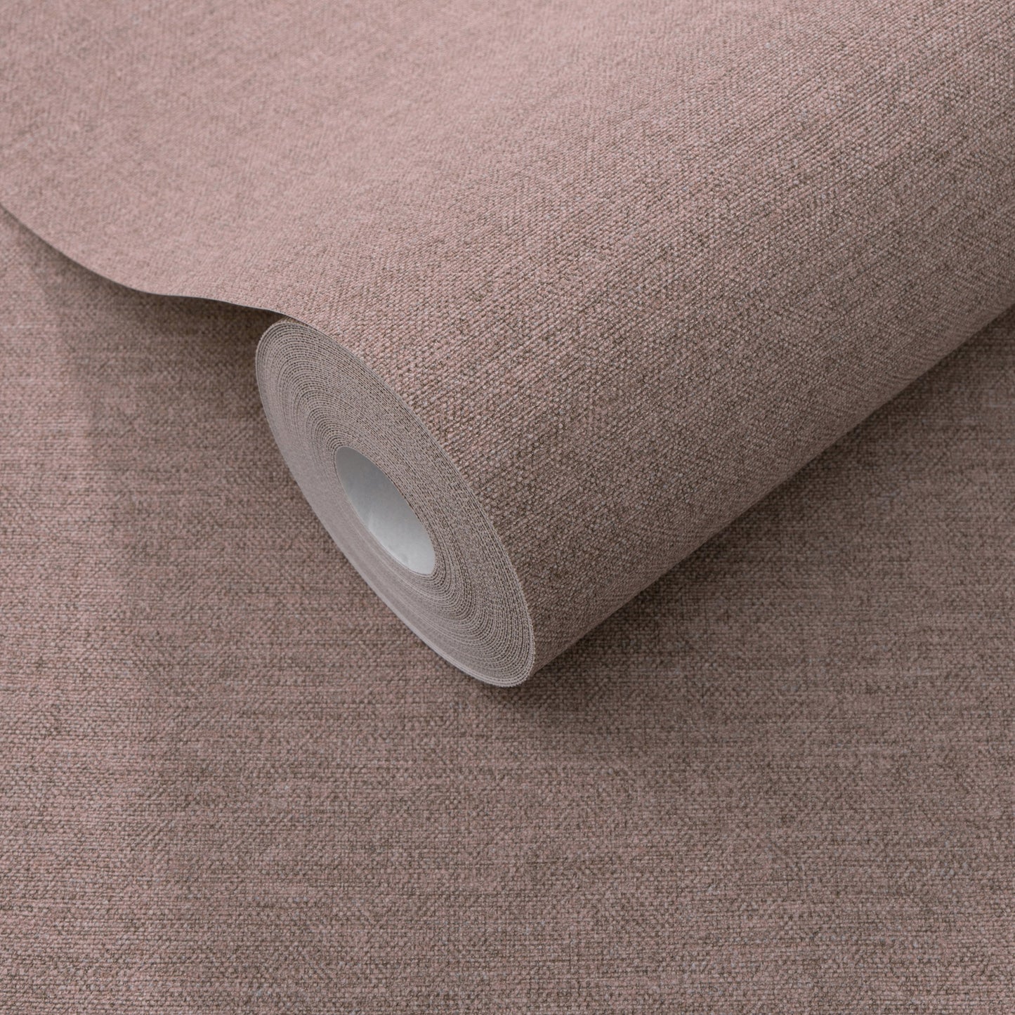 Dusty rose textured wallpaper roll with white core; traditional purple wallpaper pattern.