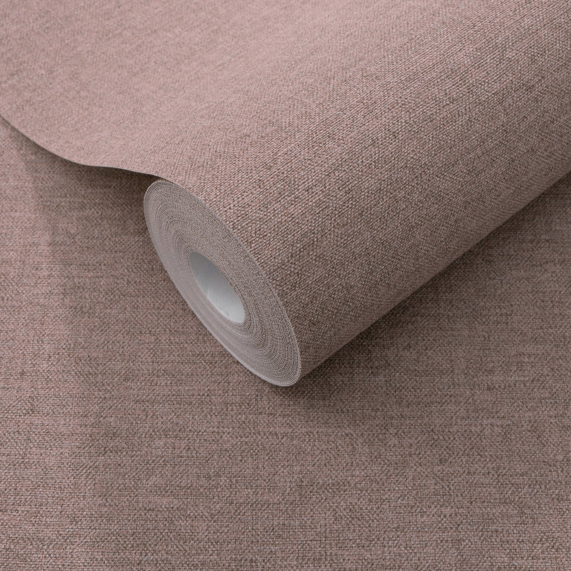 Dusty rose textured wallpaper roll with white core; traditional purple wallpaper pattern.