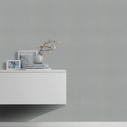 Gray wallpaper on wall with subtle linen texture.