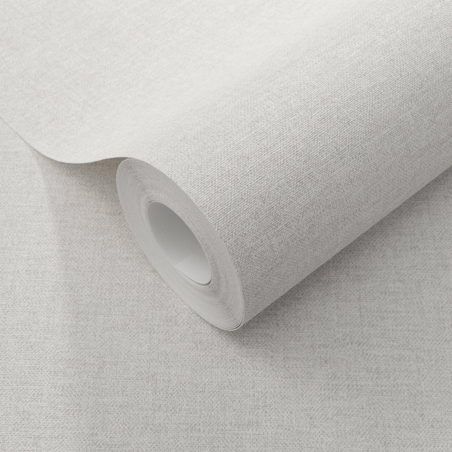 Cream linen-textured wallpaper roll with a cardboard core, partially unrolled.