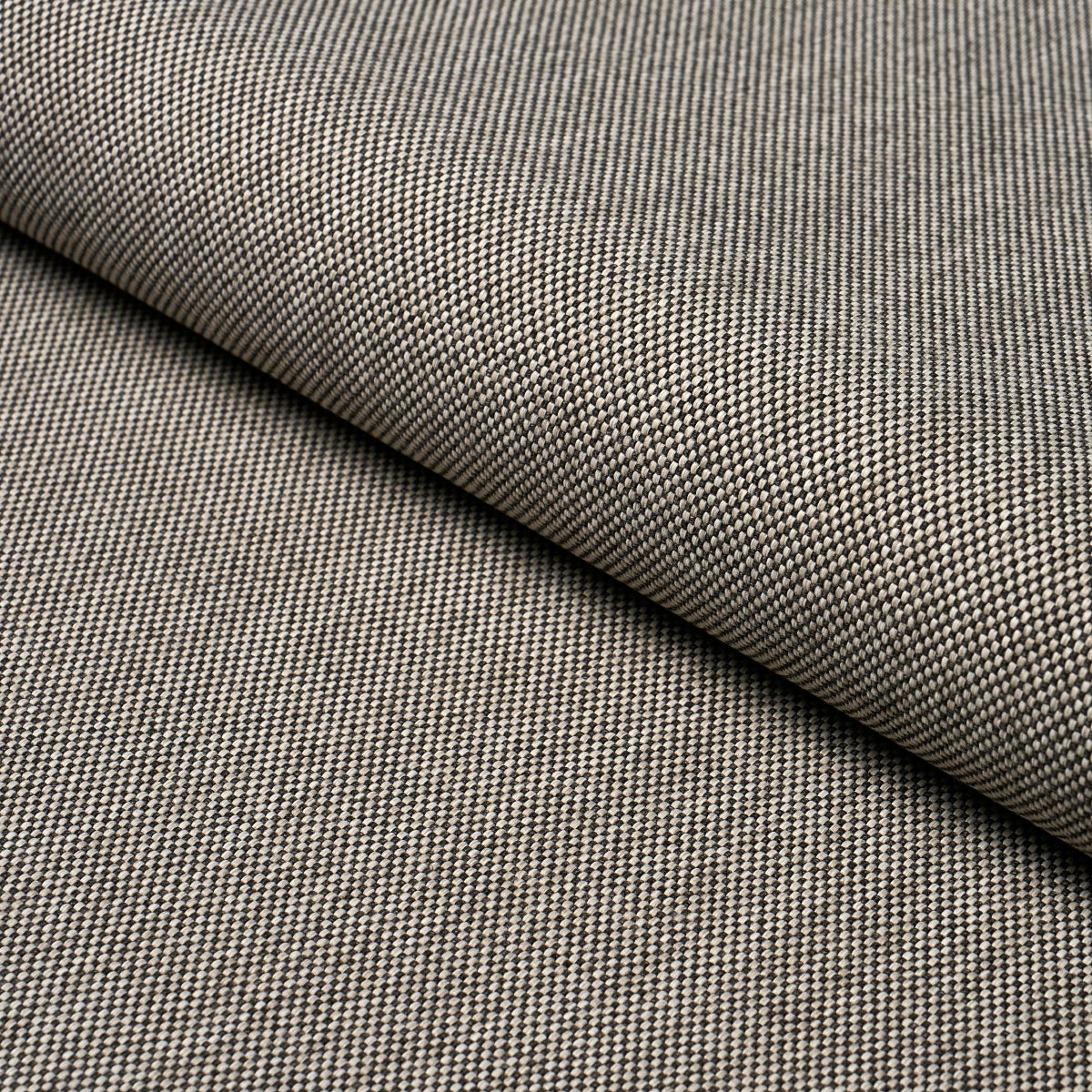 Beige and charcoal micro-check woven fabric, folded edge; fine textured tweed-like material for jackets or upholstery.