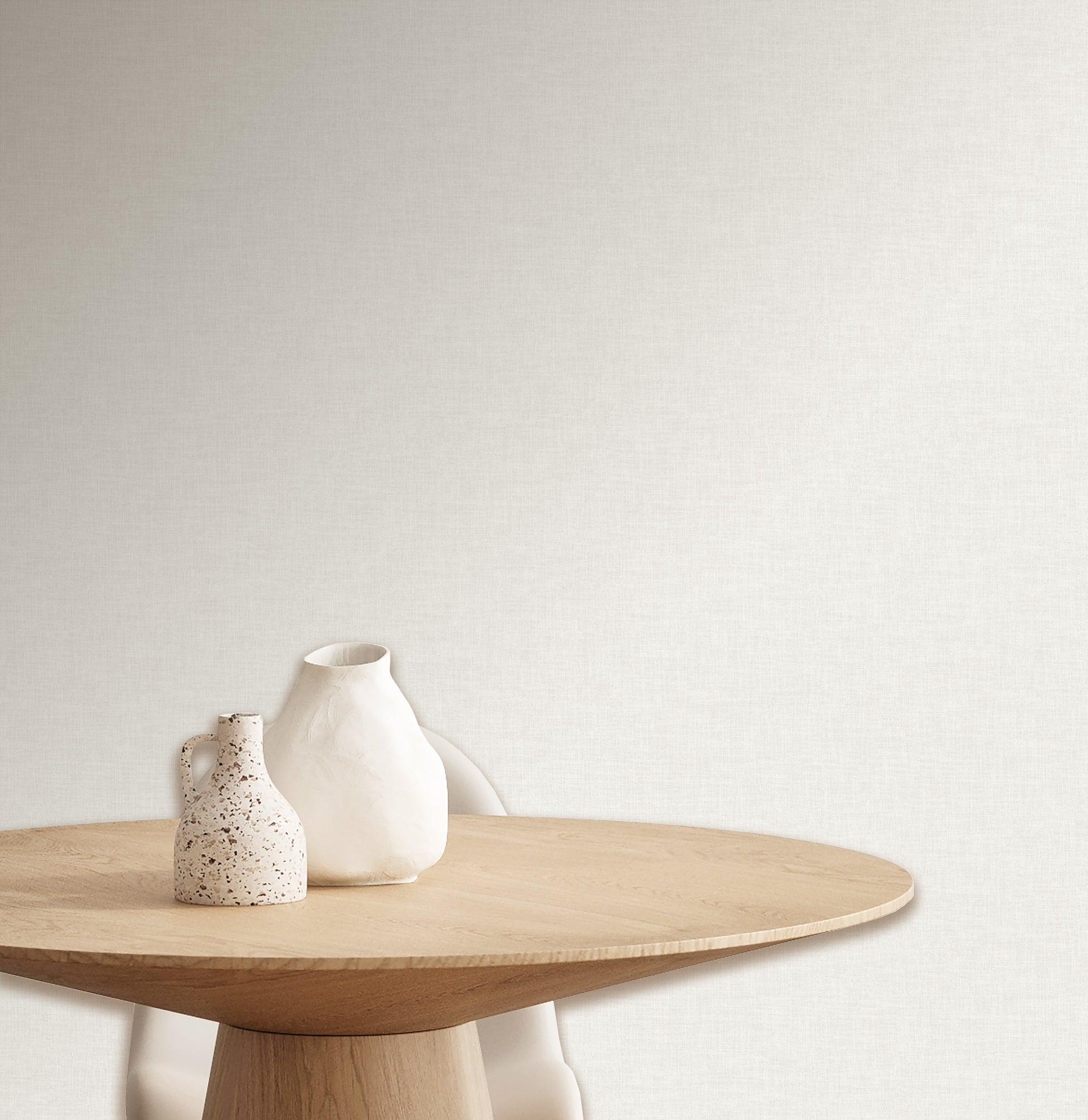 White wallpaper with a linen-weave texture and subtle contemporary pattern on a neutral backdrop.