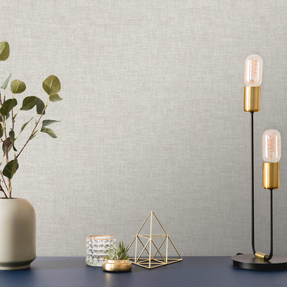 Beige wallpaper with linen-weave texture, Antibes pattern, covering a wall.