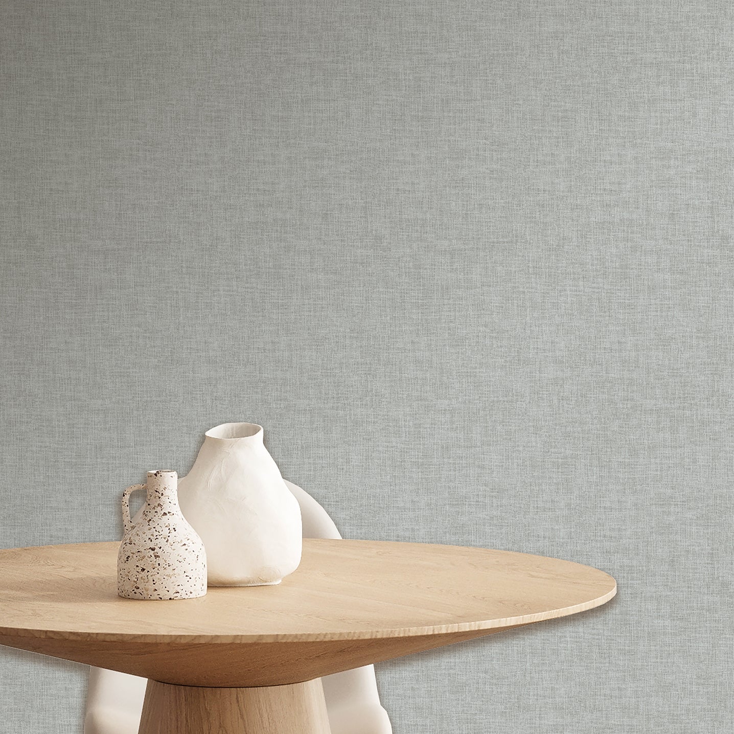 Blue linen-weave textured wallpaper pattern on a wall.