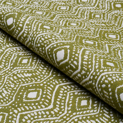 Rolled olive green and white geometric woven fabric with a diamond lattice pattern, ideal for upholstery or drapery.