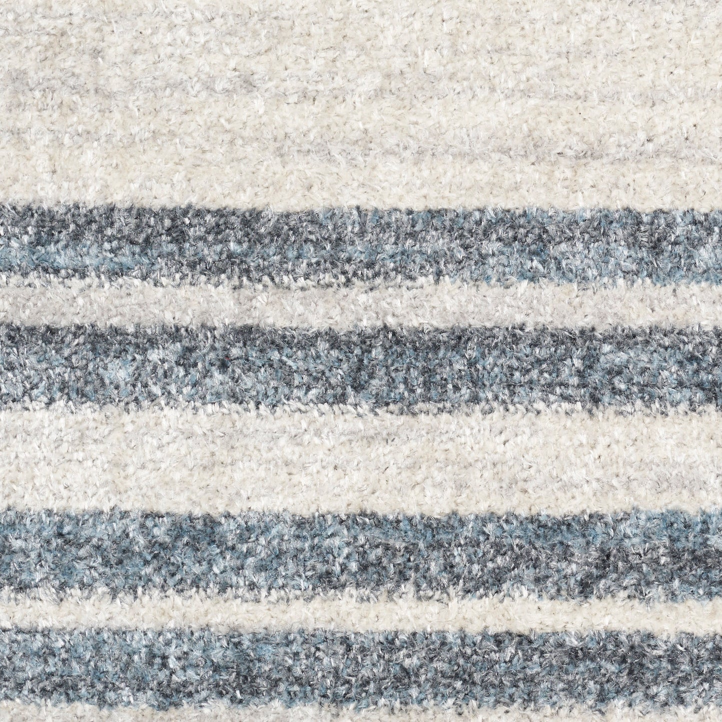 Beige and blue-gray striped shag area rug with soft, fluffy pile.