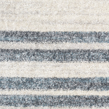 Beige and blue-gray striped shag area rug with soft, fluffy pile.