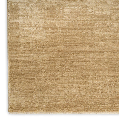 Beige-gold textured area rug with a subtle distressed pattern and short white fringe along the bottom edge.