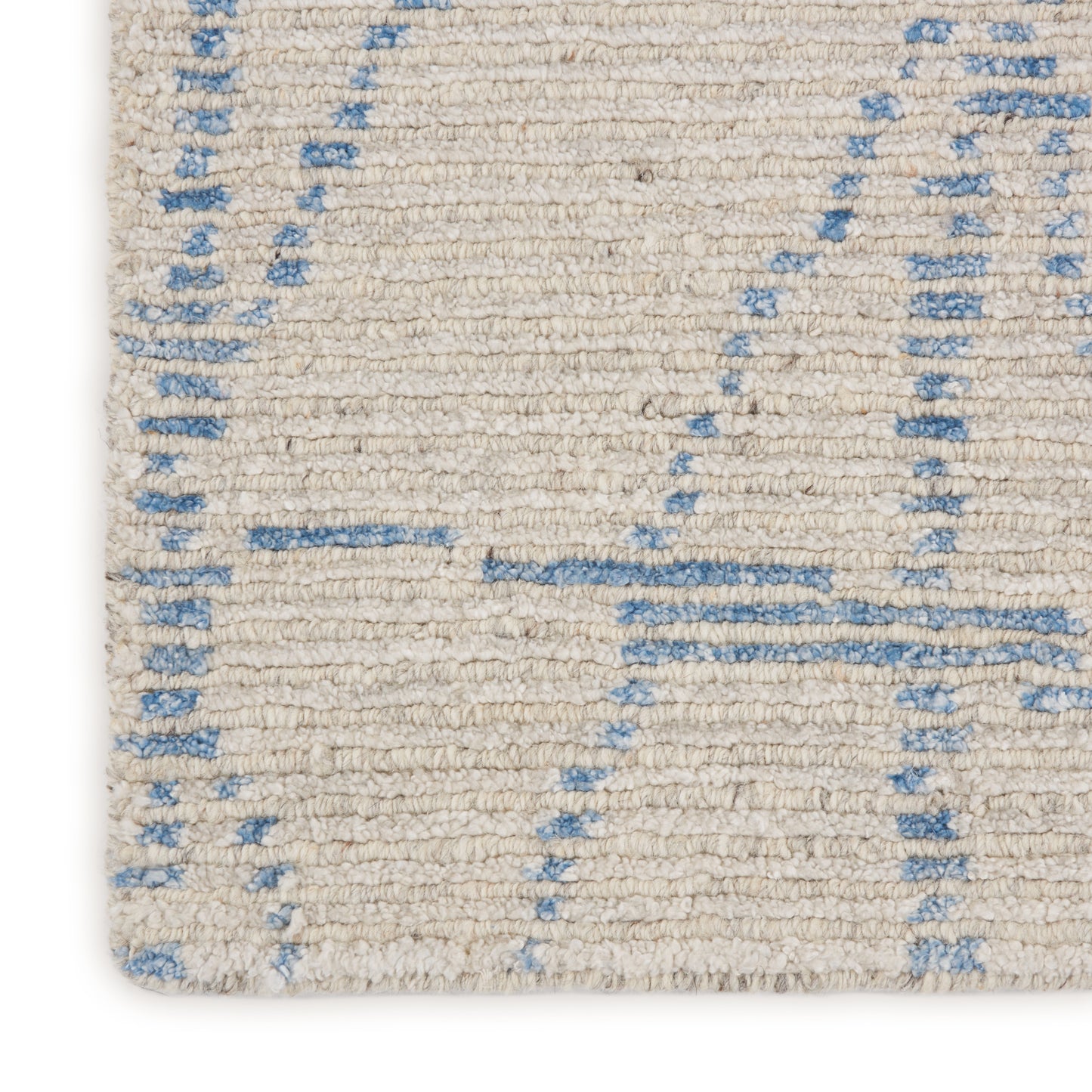 Cream woven rug with pale blue geometric lines; soft textured pile.