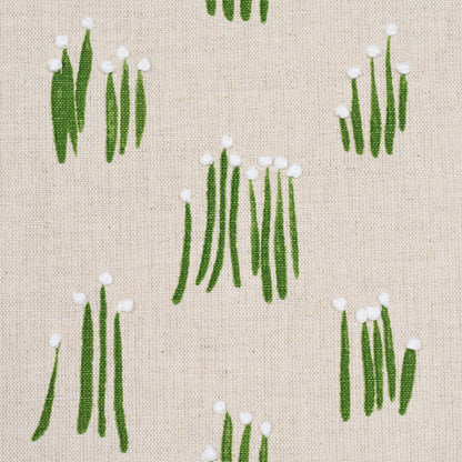 Beige linen fabric with a repeating botanical print of green vertical stalks topped with white pom-poms.