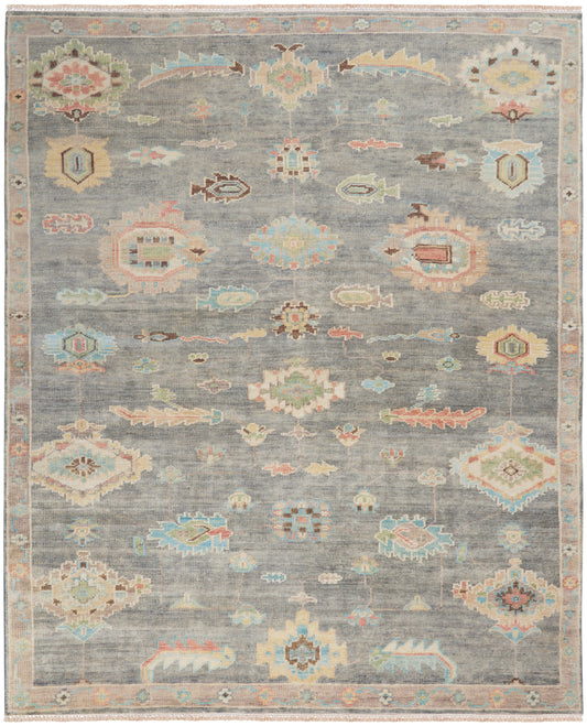 Pastel-toned vintage rug with gray-blue field and geometric floral medallions; soft pink, aqua, and mint accents; ornate border.