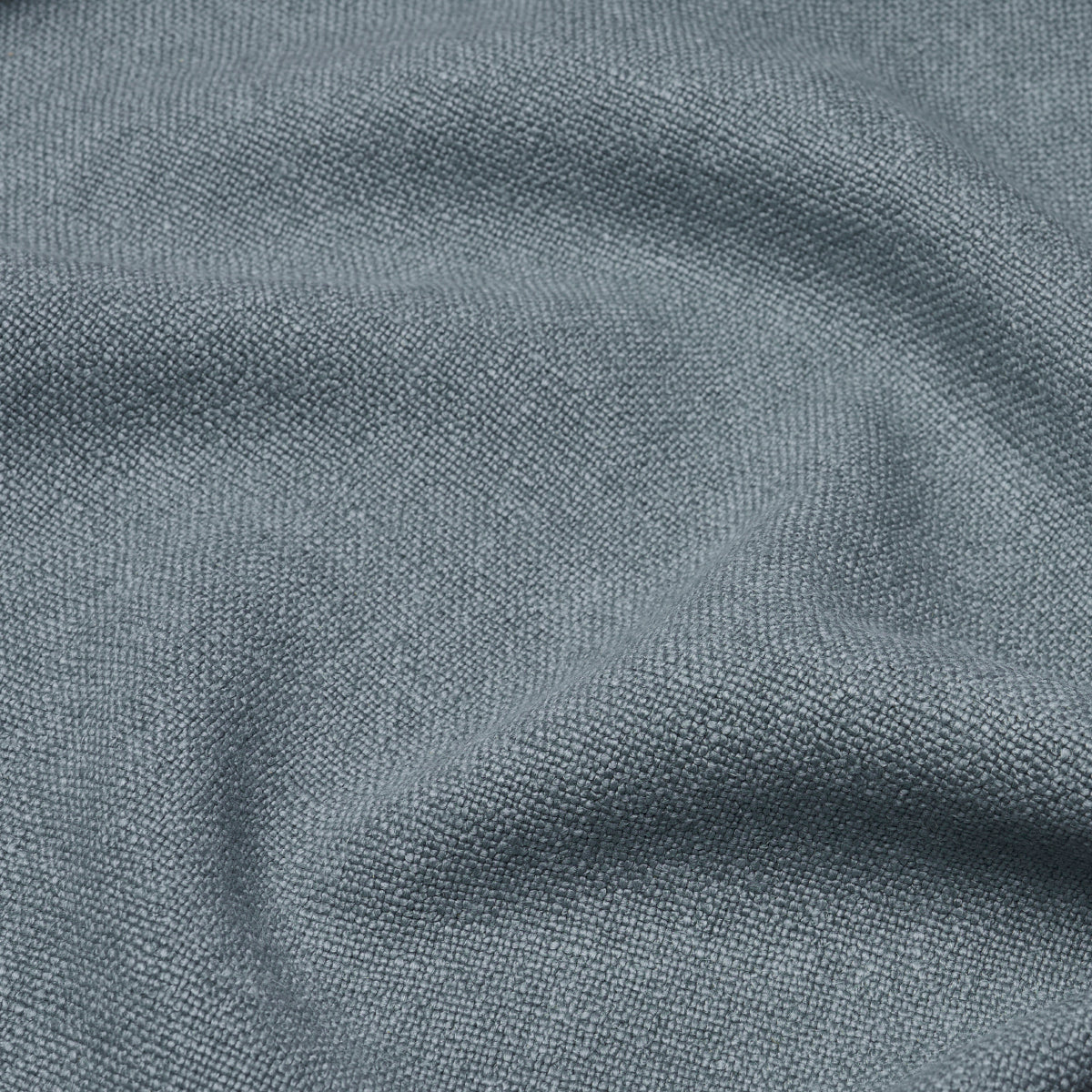 Sky blue linen solid fabric close-up with soft drape and subtle texture, suitable for clothing or home decor.