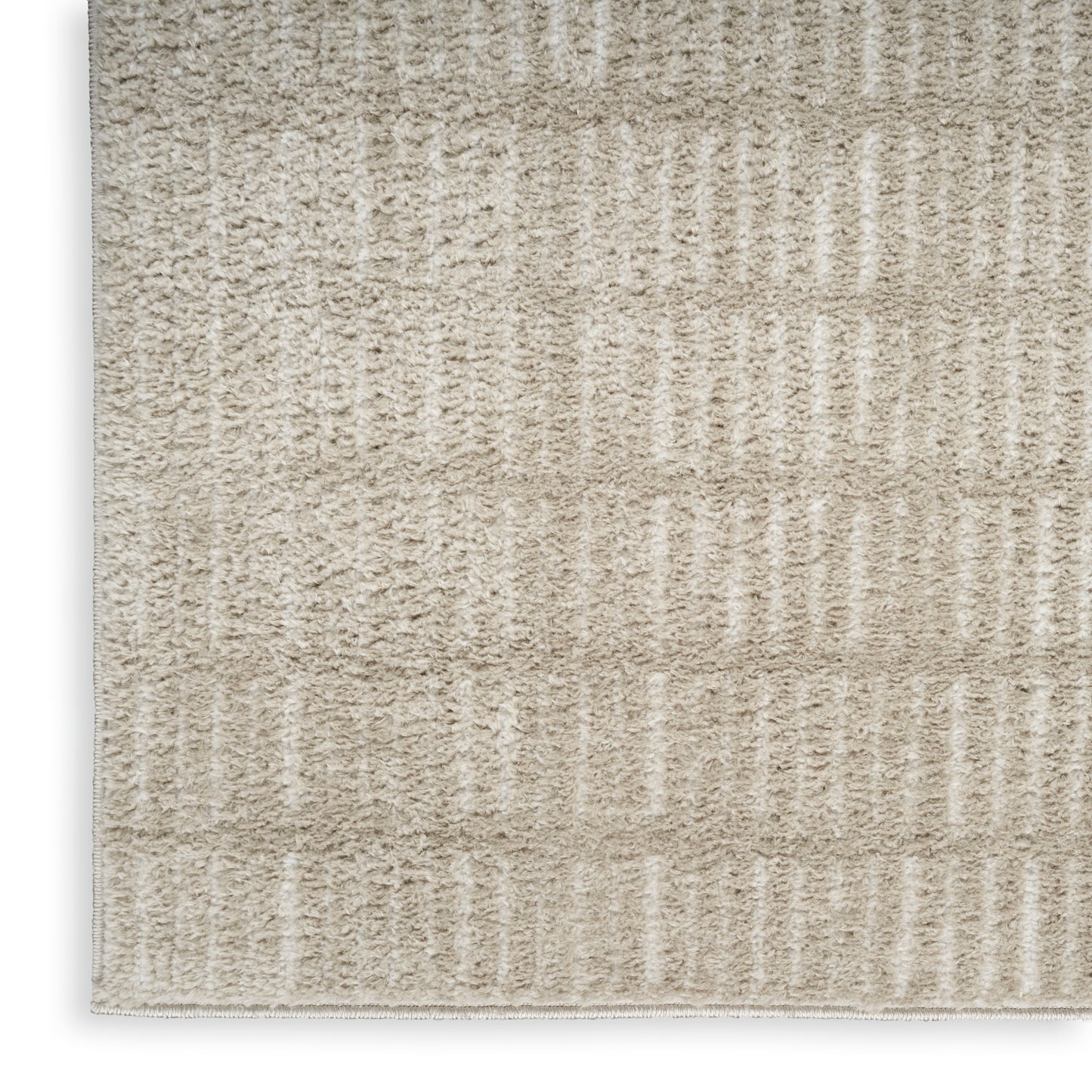Beige textured rug with soft loop pile and vertical ribbed stripes in cream tones.