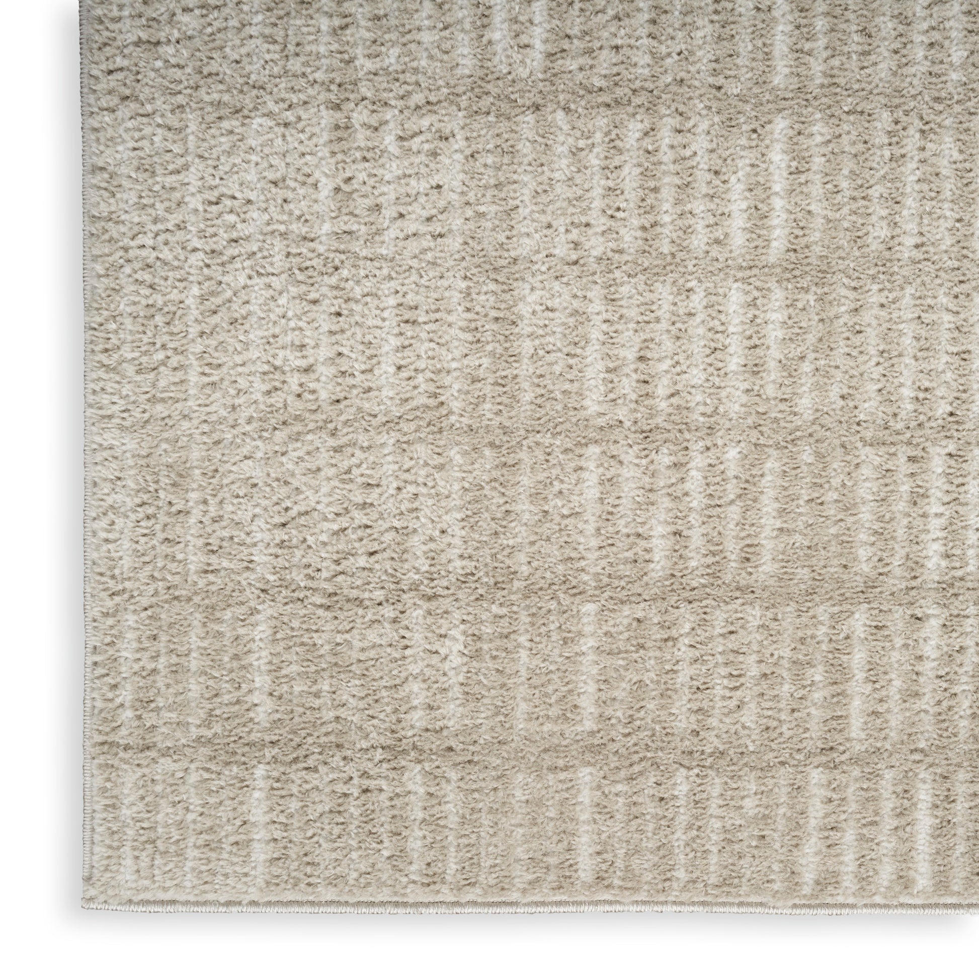 Beige textured rug with soft loop pile and vertical ribbed stripes in cream tones.