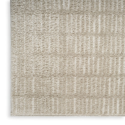 Beige textured rug with soft loop pile and vertical ribbed stripes in cream tones.
