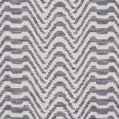 Indigo and ivory woven rug with a stepped chevron pattern; rectangular rug for living room.