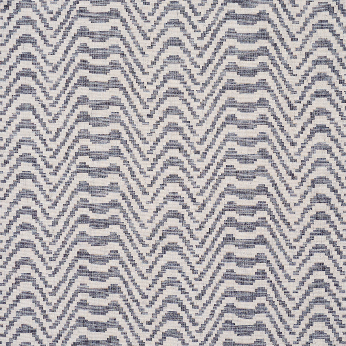 Indigo and white chevron zigzag woven textile pattern; geometric fabric for upholstery or decor.