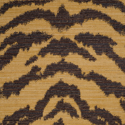 Gold tan woven rug with dark brown chevron and diamond geometric motifs in a rustic boho style.