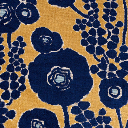 Navy blue large circular floral motifs on mustard yellow background with light blue centers and grape-like berry clusters; woven rug.