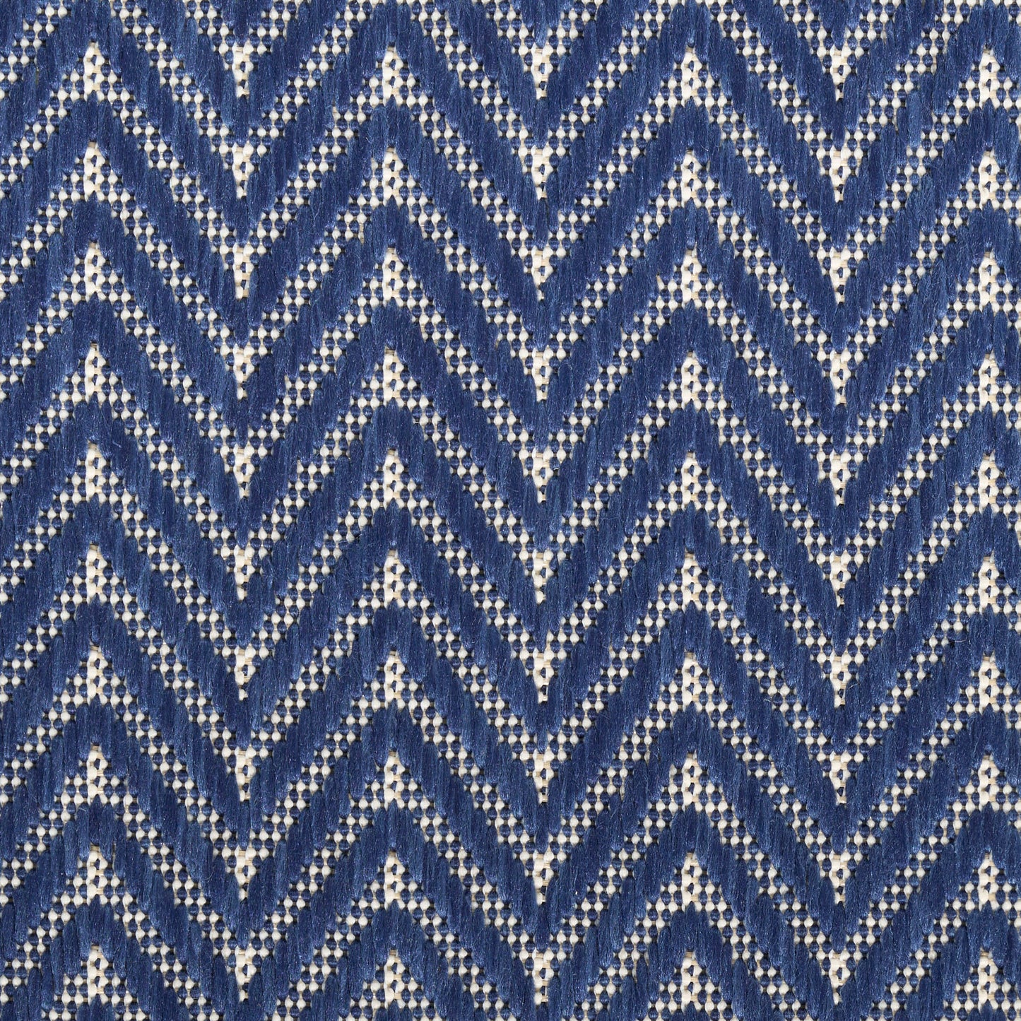 Close-up blue chevron knit fabric with white background, textured yarn.