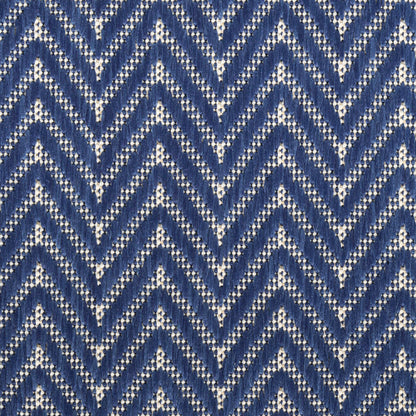 Close-up blue chevron knit fabric with white background, textured yarn.