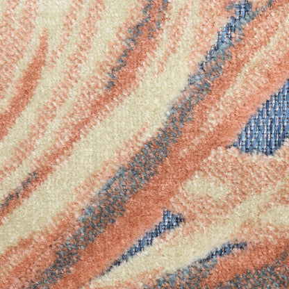 Close-up of a plush rug with cream, peach and rust stripes and blue accent lines.