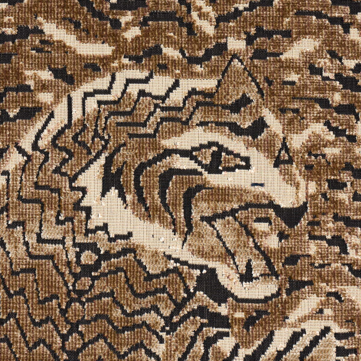 Brown, beige and black woven rug with zigzag, abstract pattern and textured surface.