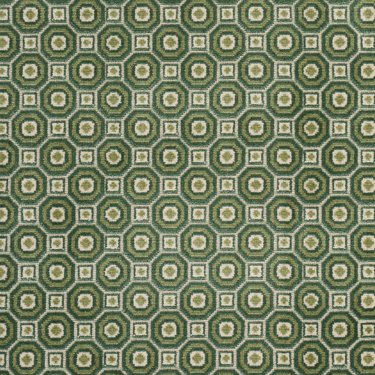 Olive-green and cream geometric textile with concentric circles and square motifs in a retro tile pattern.