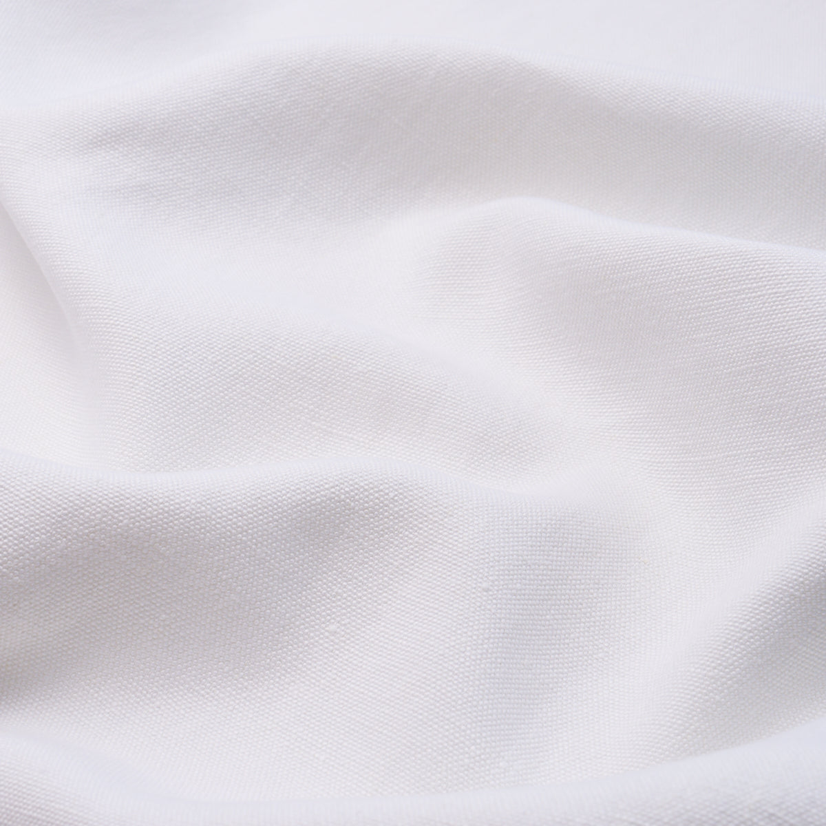 White cotton fabric with soft draped folds and subtle weave texture.