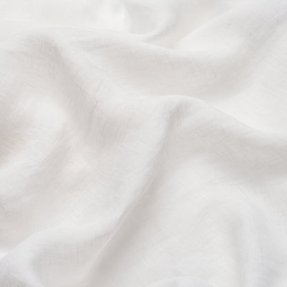White fabric with soft folds and subtle woven texture, versatile for linens or clothing.