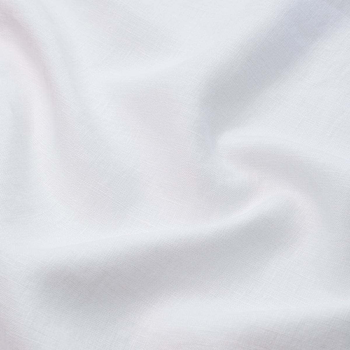 White fabric with soft drapes and subtle woven texture.