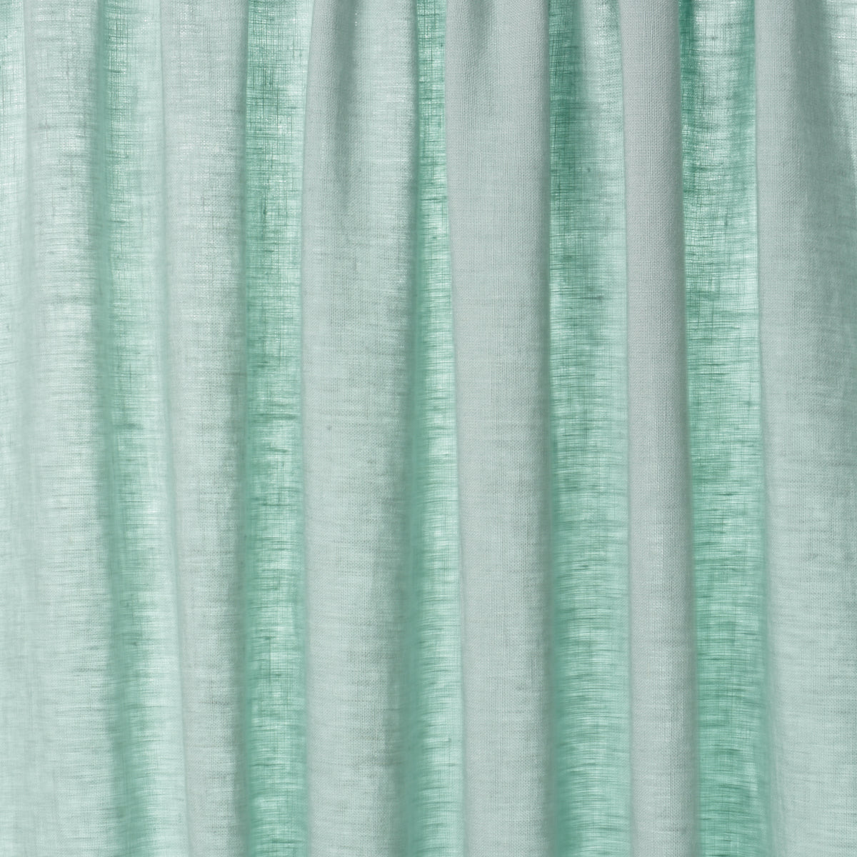 Mint green, linen-textured curtains with vertical folds for airy, modern window decor.
