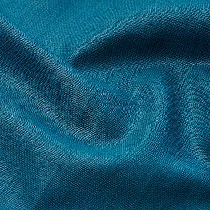 Teal-blue woven fabric close-up with soft folds and visible texture.