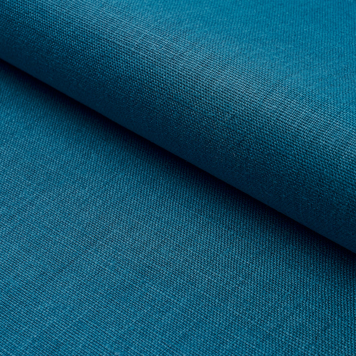 Close-up teal blue woven fabric with a rolled edge and visible textured weave.