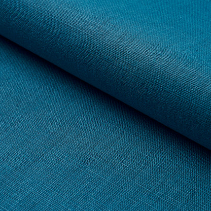 Close-up teal blue woven fabric with a rolled edge and visible textured weave.