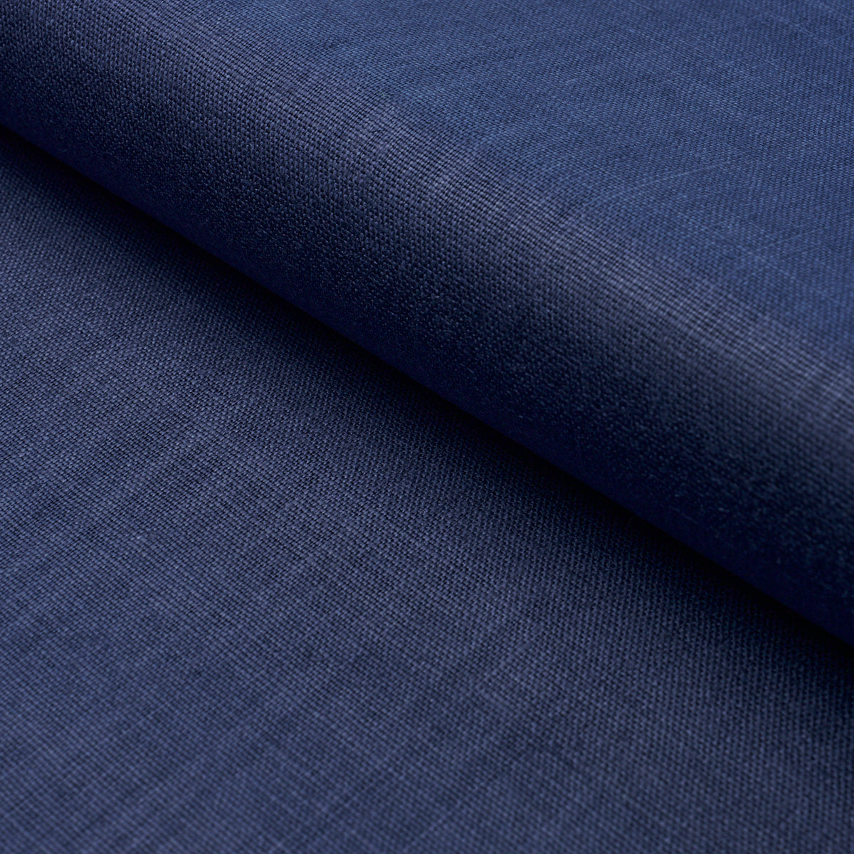 Close-up of dark navy blue fabric with visible weave, folded roll; versatile textile for clothing or upholstery.